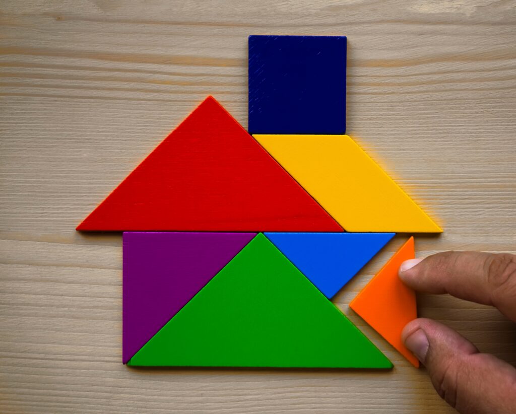 Male-hand-build-model-of-House-Made-Of-Wooden-colorful-scaled